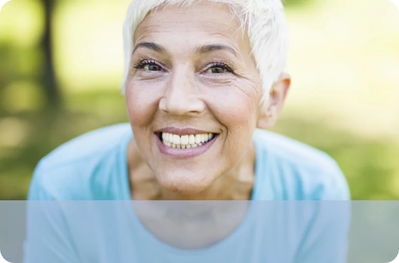 Older woman with white hair smiling