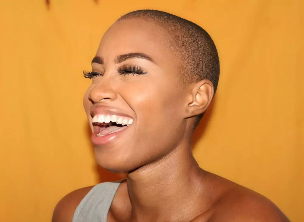 Woman with shaved head laughing