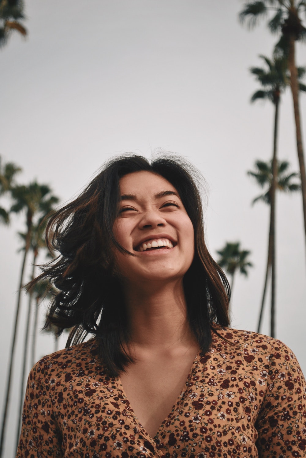 Young women by palm trees