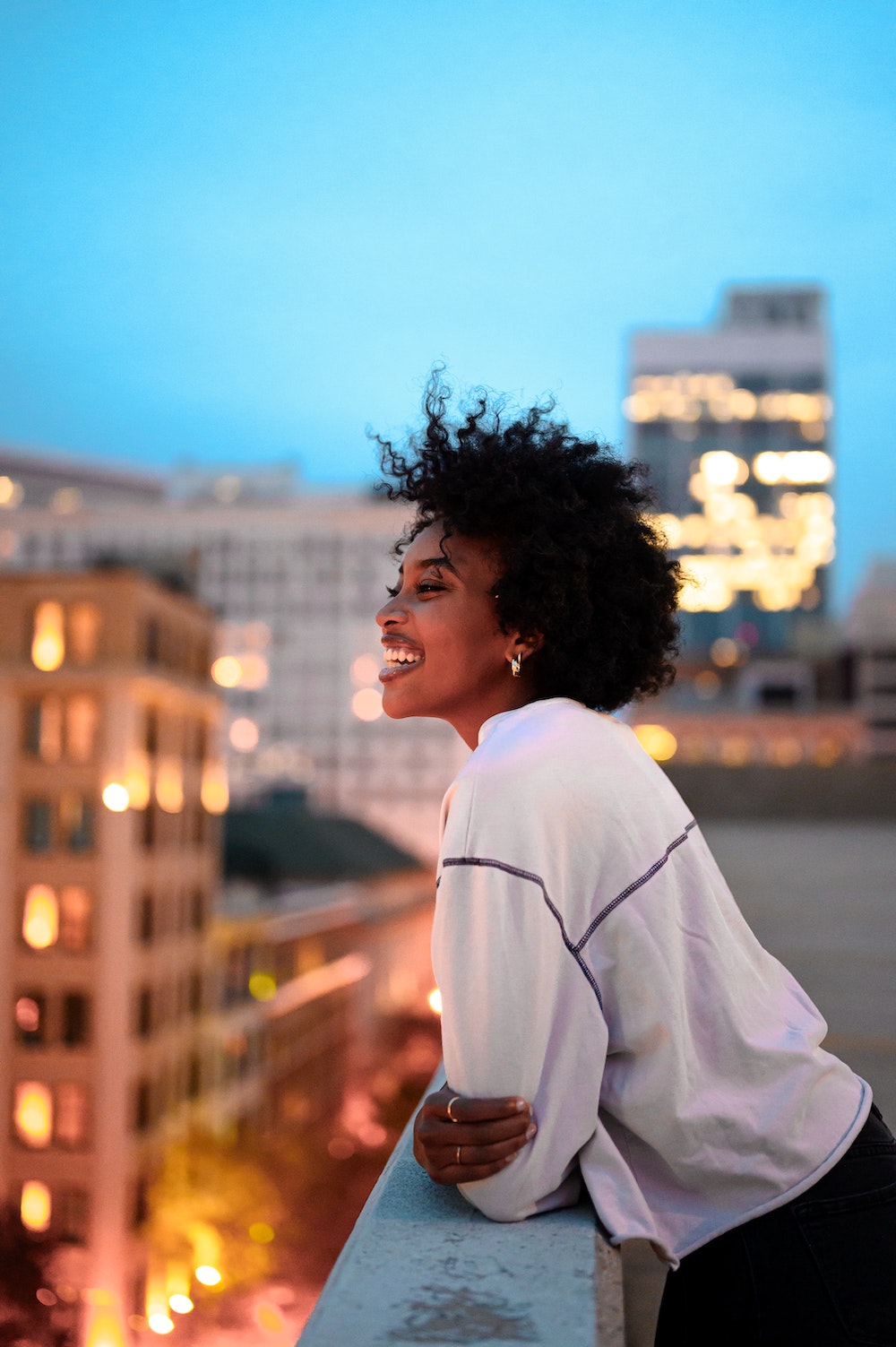 Young women on rooftop smiling
