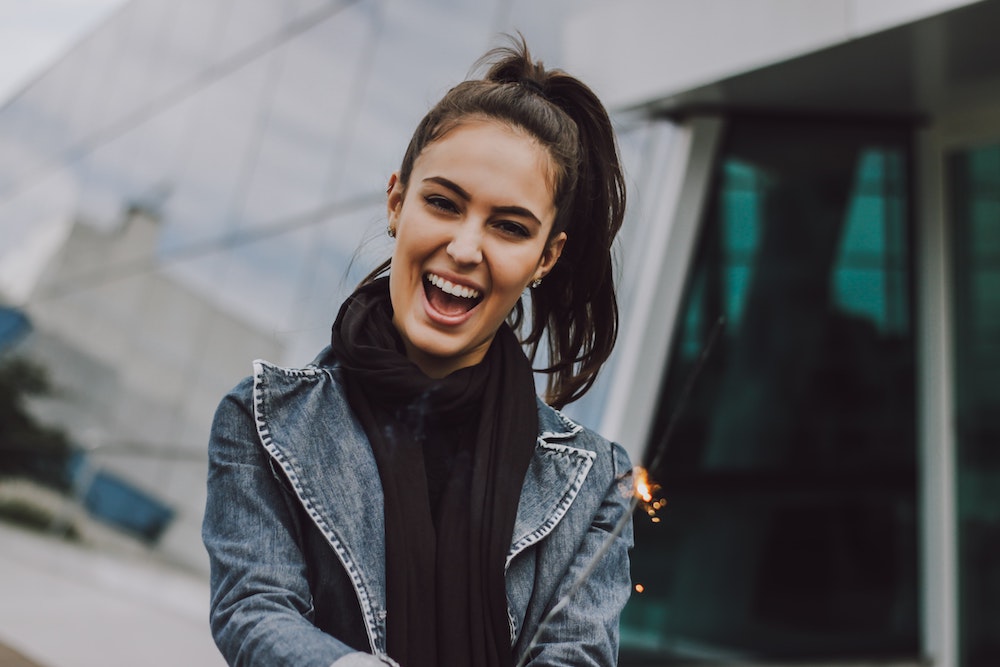 Young woman in ponytail laughing